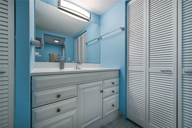 bathroom featuring vanity and a textured ceiling