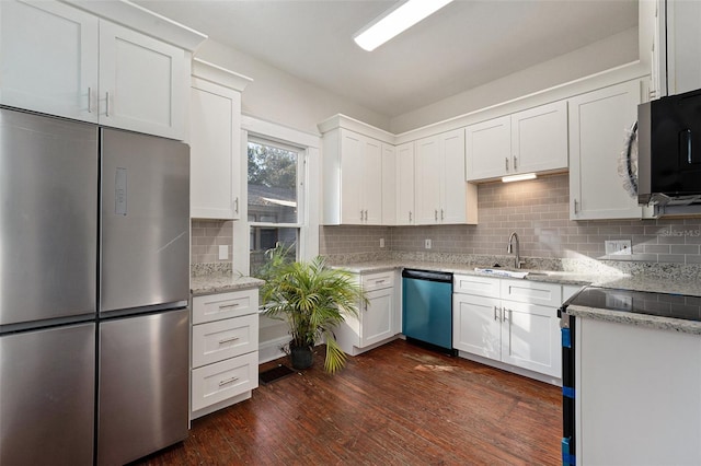 kitchen with dark hardwood / wood-style flooring, white cabinets, and appliances with stainless steel finishes