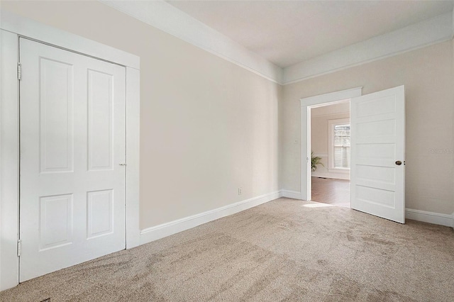 unfurnished bedroom with carpet and a closet