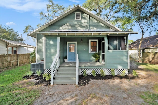 bungalow-style house with central AC unit and a porch