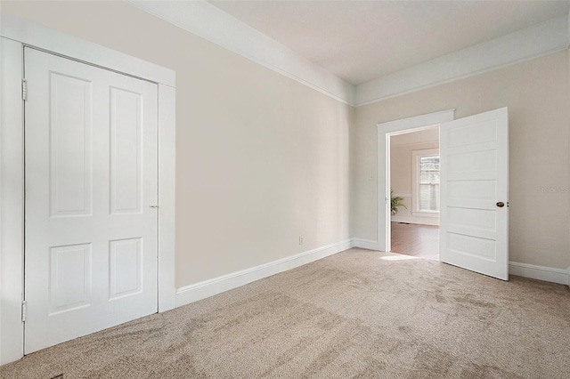 unfurnished bedroom featuring carpet flooring and baseboards