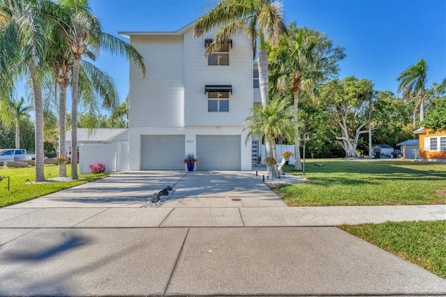 view of front of property with a front yard and a garage