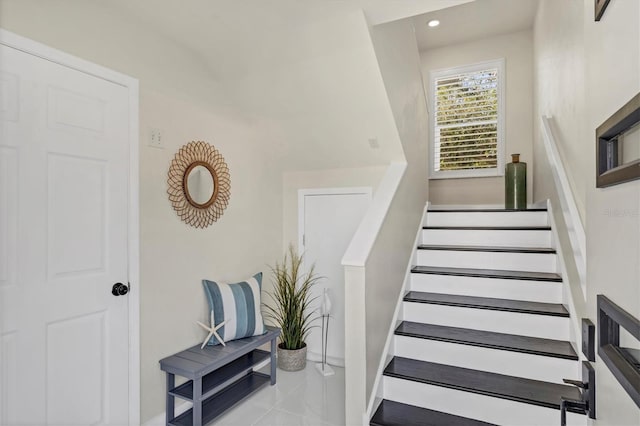 stairway with tile patterned flooring