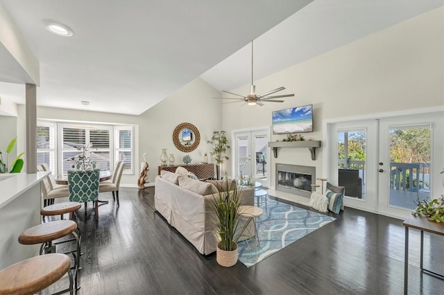 living room with dark hardwood / wood-style flooring, ceiling fan, french doors, and lofted ceiling