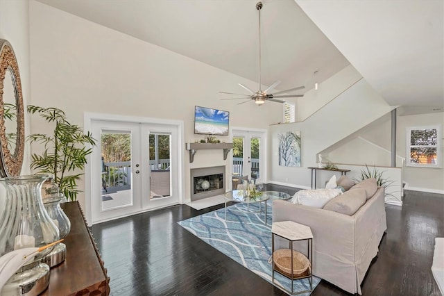 living room with ceiling fan, dark wood-type flooring, high vaulted ceiling, and french doors