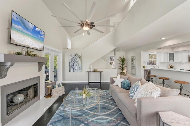 living room featuring dark hardwood / wood-style flooring and ceiling fan