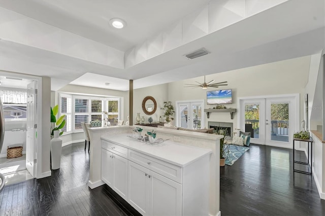 kitchen with ceiling fan, white cabinetry, dark wood-type flooring, and french doors