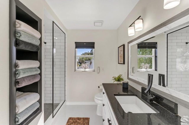 bathroom with tile patterned floors, a shower with door, vanity, and toilet