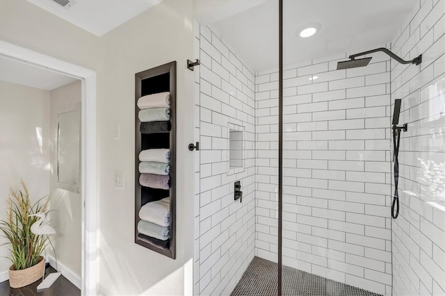 bathroom with a tile shower