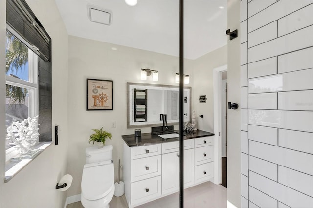 bathroom featuring vanity and toilet