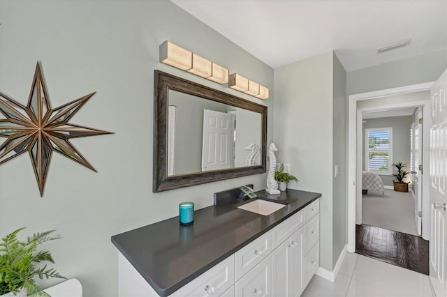 bathroom featuring tile patterned flooring and vanity