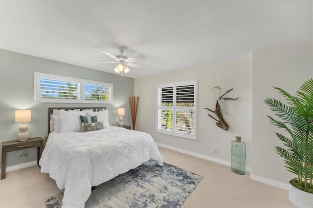 bedroom featuring ceiling fan and light colored carpet