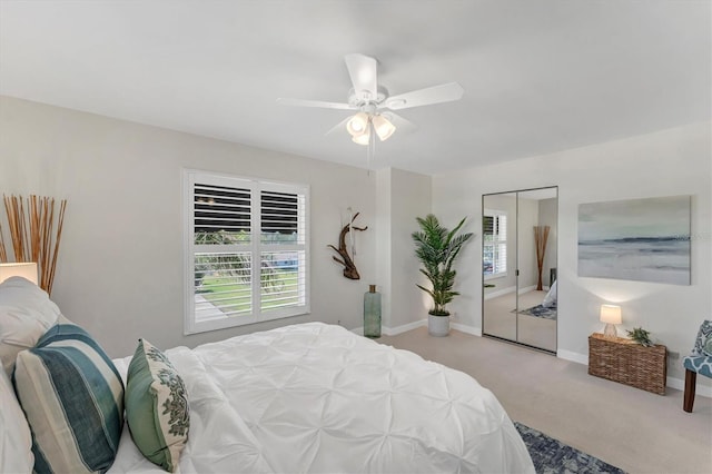 bedroom featuring a closet, ceiling fan, and light colored carpet