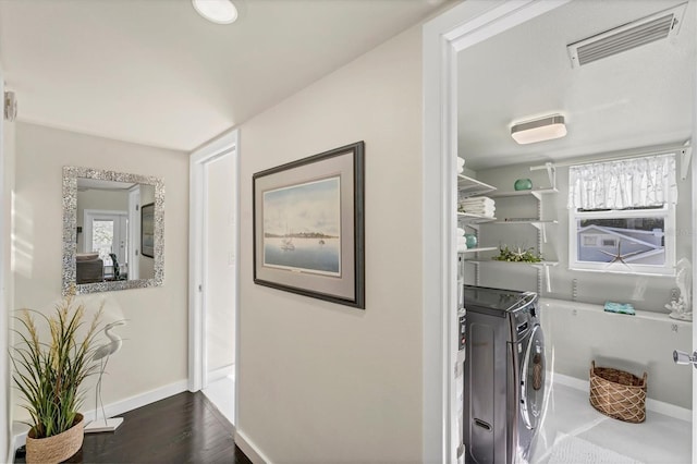 laundry area with dark wood-type flooring