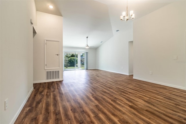 unfurnished living room with dark hardwood / wood-style flooring, high vaulted ceiling, and ceiling fan with notable chandelier