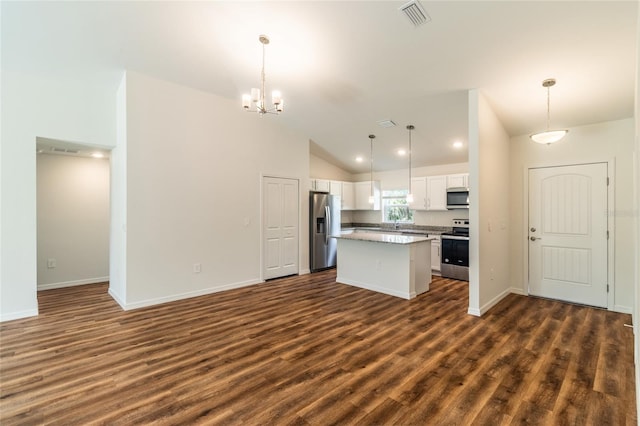 kitchen featuring pendant lighting, white cabinets, a center island, and stainless steel appliances