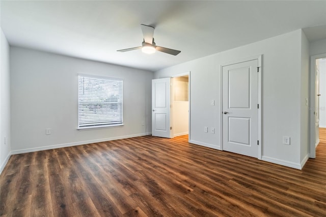 unfurnished bedroom with ceiling fan and dark hardwood / wood-style flooring