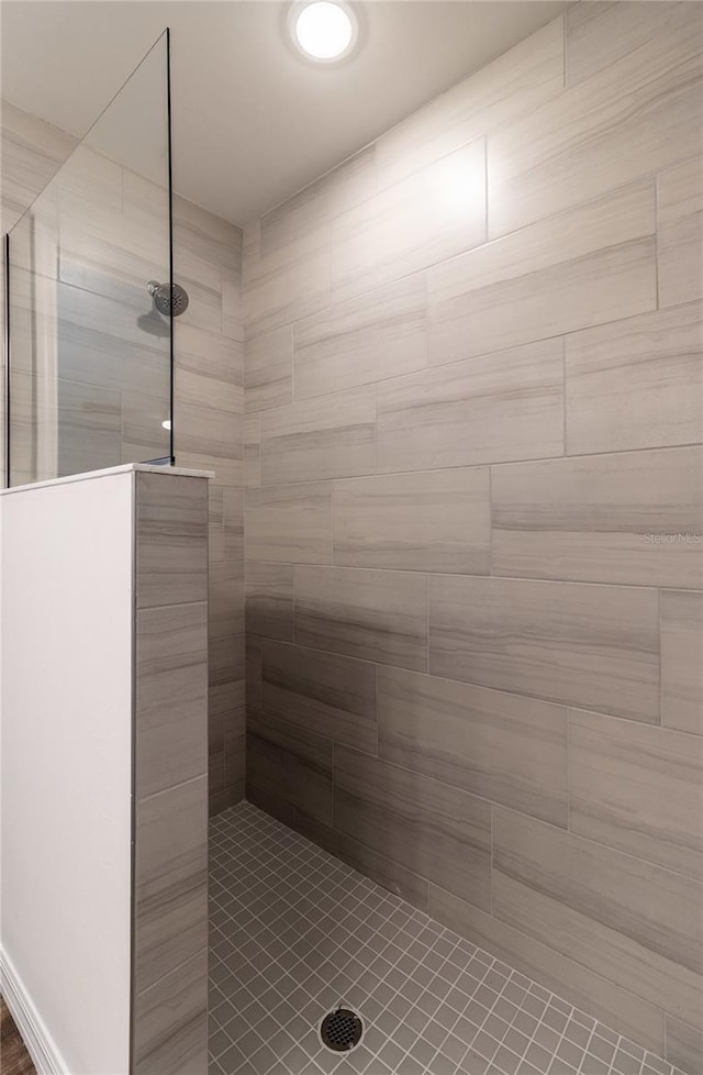 bathroom with tiled shower