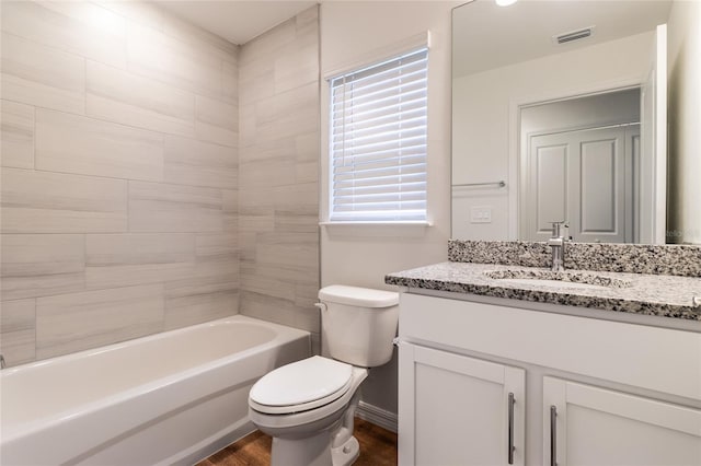 full bathroom featuring shower / washtub combination, hardwood / wood-style floors, vanity, and toilet