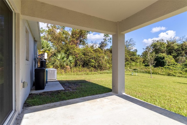 view of yard with cooling unit and a patio area