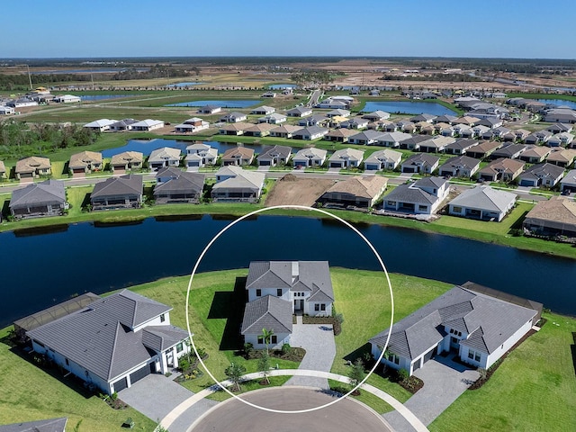 birds eye view of property with a water view