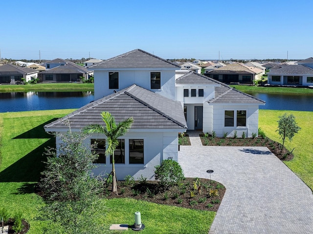 view of front of home featuring a water view and a front lawn