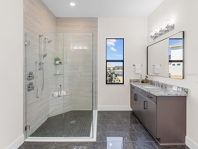 bathroom with vanity and a shower with door