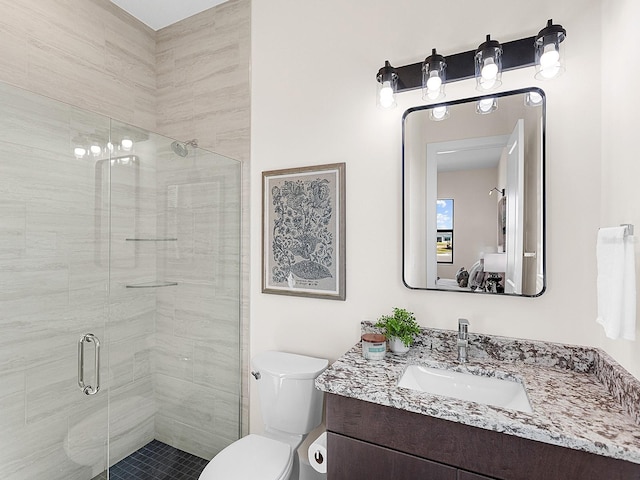 bathroom with vanity, toilet, and walk in shower