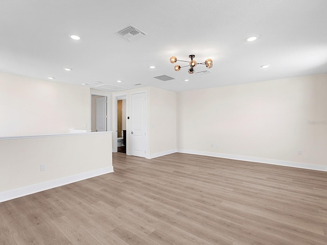 spare room with light hardwood / wood-style flooring