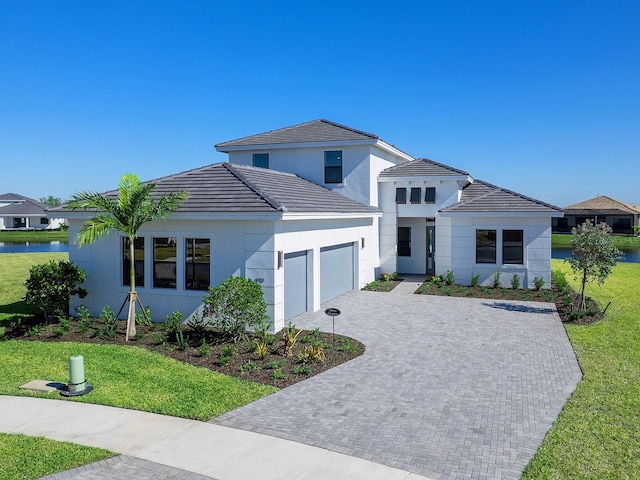 view of front of home featuring a garage and a front lawn