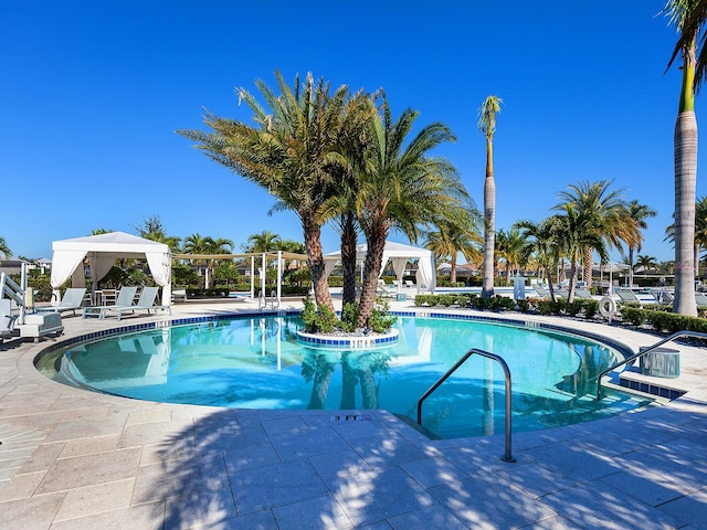 view of swimming pool featuring a gazebo and a patio