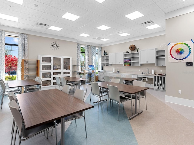 dining room with a paneled ceiling and sink