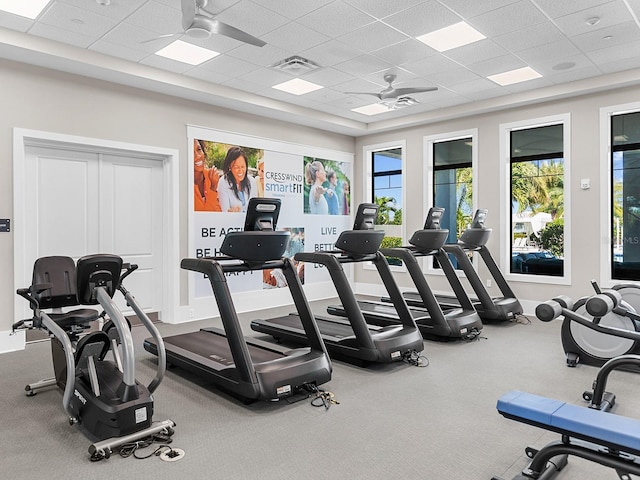 workout area featuring ceiling fan and a drop ceiling