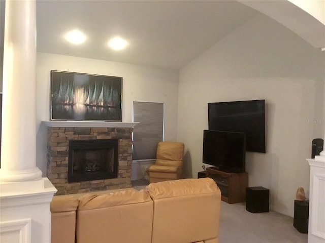 living room featuring carpet flooring, a stone fireplace, and lofted ceiling