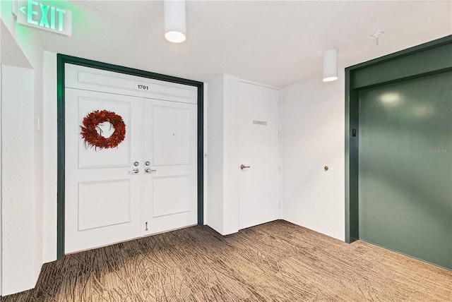 view of carpeted entrance foyer