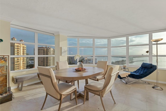 sunroom with a water view and a healthy amount of sunlight