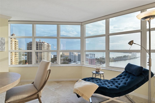 sunroom featuring a water view and plenty of natural light