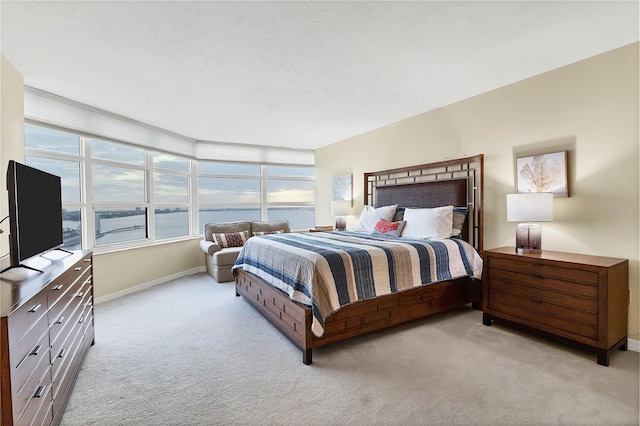 bedroom featuring light colored carpet