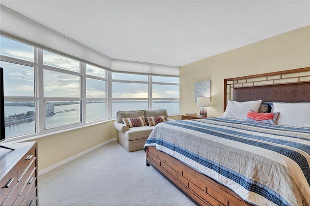 carpeted bedroom featuring a water view