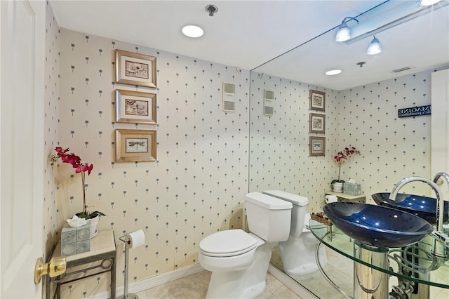 bathroom with tile patterned floors and toilet