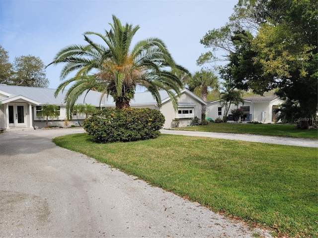 view of front of home featuring french doors and a front yard