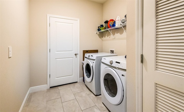 laundry room with light tile patterned floors and washing machine and clothes dryer