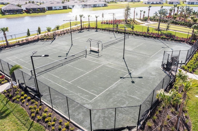 view of sport court with a water view