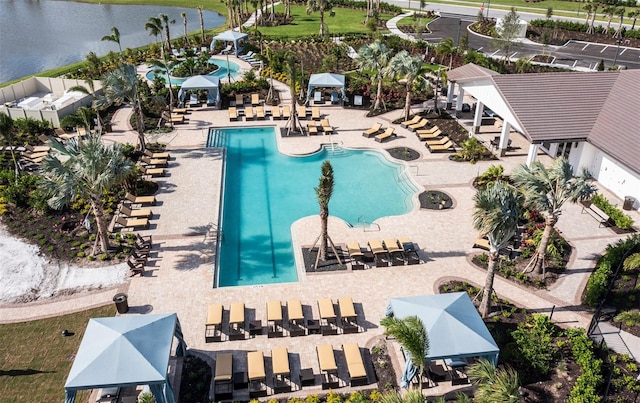 view of swimming pool with a gazebo and a water view