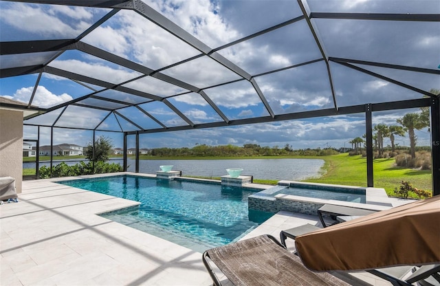 view of pool with glass enclosure, a patio area, a water view, and an in ground hot tub