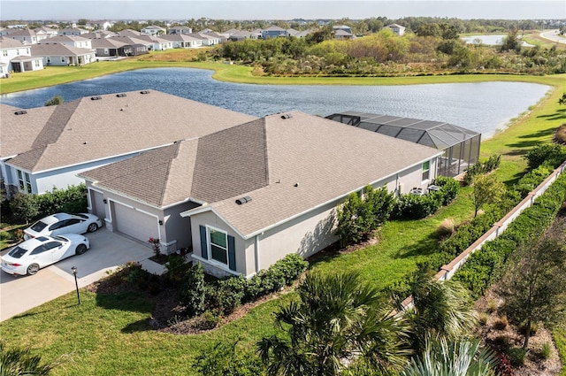 drone / aerial view featuring a residential view and a water view