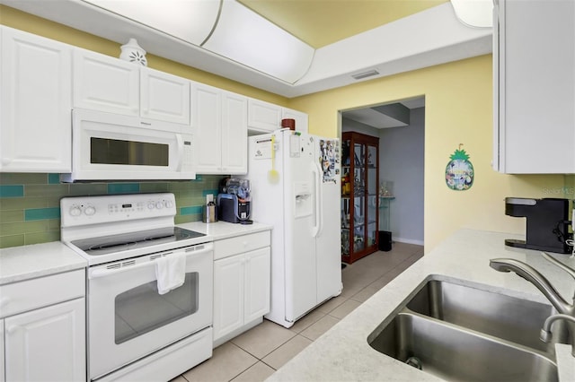 kitchen with white cabinetry, sink, white appliances, and backsplash