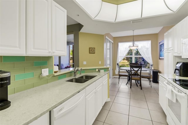 kitchen with white cabinetry, light tile patterned floors, pendant lighting, sink, and white appliances