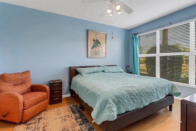 bedroom featuring ceiling fan and light hardwood / wood-style flooring