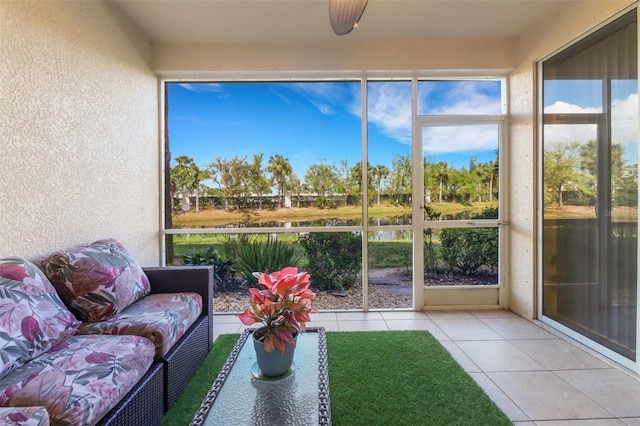 sunroom featuring a water view